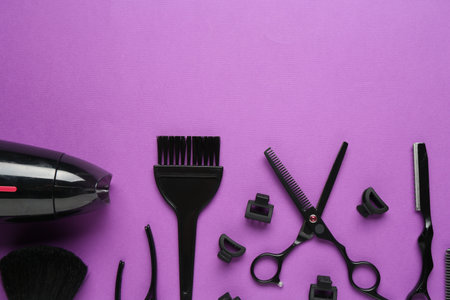 Different hairdresser's tools on violet background, flat lay. Space for textの写真素材