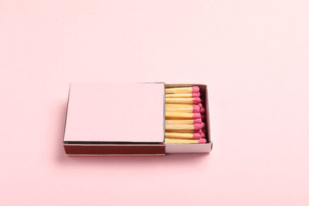 Matches in box on pink background, closeup. Mockup for designの写真素材