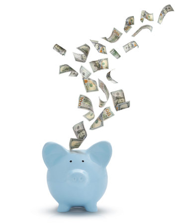 Dollar banknotes falling into piggy bank on white backgroundの写真素材