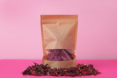 One zipper stand-up pouch with dry flowers on pink background. Mockup for designの写真素材