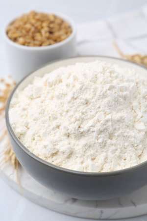 Wheat flour, grain and spikes on white table, closeupの写真素材