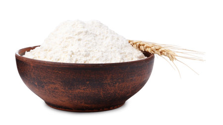 Wheat flour in bowl and spike on white backgroundの写真素材