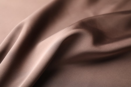 Crumpled light brown silk fabric as background, closeupの写真素材