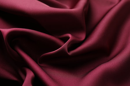 Crumpled burgundy silk fabric as background, closeupの写真素材