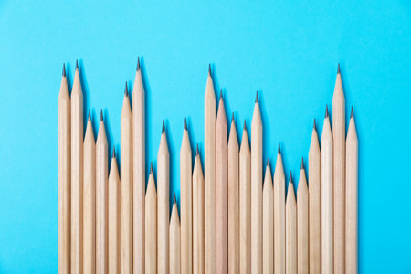 Many graphite pencils on light blue background, flat layの写真素材