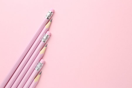 Many graphite pencils on pink background, flat lay. Space for textの写真素材