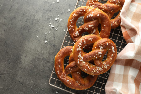Tasty pretzels with salt on grey table, top view. Space for textの写真素材