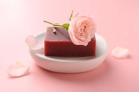 Soap bar and beautiful rose on pink background, closeupの写真素材