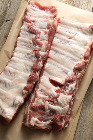 Raw pork ribs on wooden table, top viewの写真素材