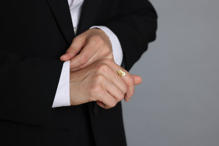 Person in suit on grey background, closeup. Space for textの写真素材