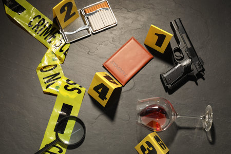 Forensic expertise. Crime scene with evidence, markers and police tape on grey background, flat lay