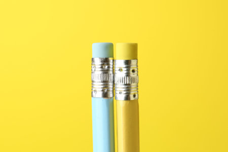 Graphite pencils with erasers on yellow background, closeupの写真素材