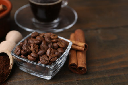 Roasted beans, instant coffee powder and cinnamon sticks on wooden table, closeupの写真素材