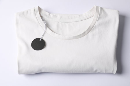 T-shirt with tag on white background, top viewの写真素材