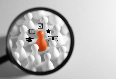 Employee search. Orange pawn among white ones, view through magnifying glass