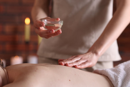 Woman receiving back massage with oil in spa salon, closeupの写真素材