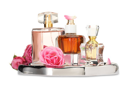 Many different perfume bottles and roses isolated on whiteの写真素材