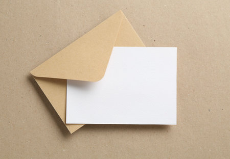 Blank invitation card and envelope on carton, top view. Space for designの写真素材