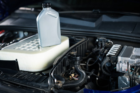 Bottle of motor oil on car engine, closeupの写真素材