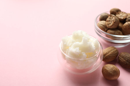 Natural shea butter on pink background, closeup. Space for textの写真素材