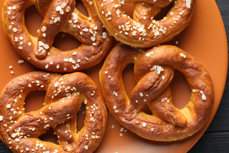 Tasty pretzels with salt on table, top viewの写真素材