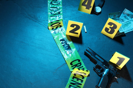 Forensic expertise. Crime scene with evidence, markers and police tape on blue background, flat lay....