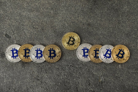 Cryptocurrency. Bitcoins on gray table, flat lay