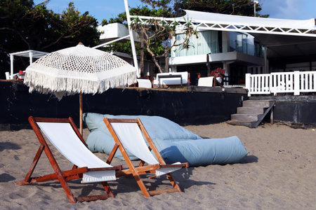Wooden deck chairs and beach umbrella at resort