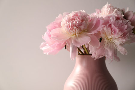 Bouquet of beautiful peonies on light gray background, closeup. Space for textの写真素材
