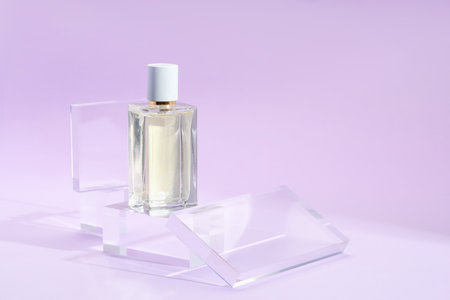 Stylish presentation of perfume bottle on violet background, closeupの写真素材