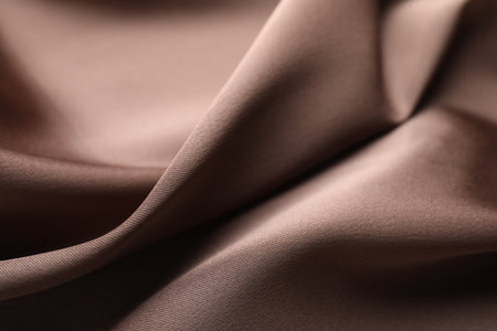 Crumpled light brown silk fabric as background, closeupの写真素材