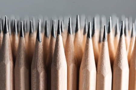 Many graphite pencils on gray background, macro view
