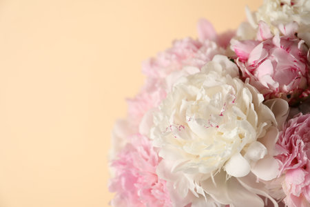 Bouquet of beautiful peonies on beige background, closeup. Space for textの写真素材