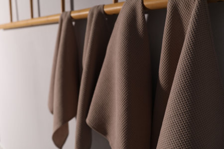 Clean waffle towels hanging on light wall, closeupの写真素材