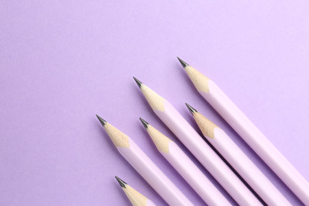 Many graphite pencils on violet background, flat lay. Space for textの写真素材