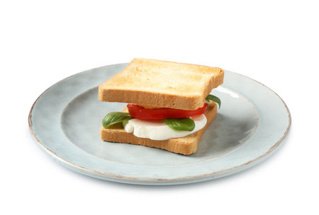Tasty sandwich with mozzarella cheese, tomato and basil on white backgroundの写真素材
