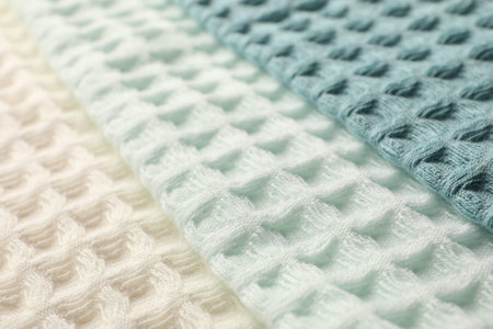 Different colorful waffle towels as background, closeup