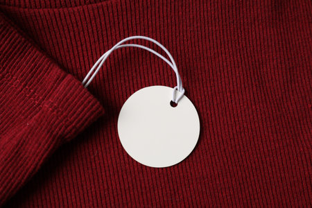 Cardboard tag on red garment, top viewの写真素材