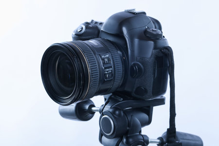 Modern professional video camera on white background, closeup