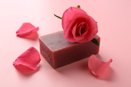 Soap bar and beautiful rose on pink background, closeupの写真素材