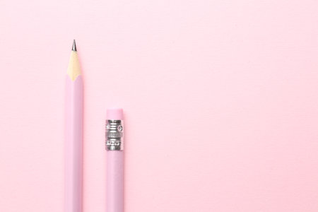 Two graphite pencils on pink background, flat lay. Space for textの写真素材