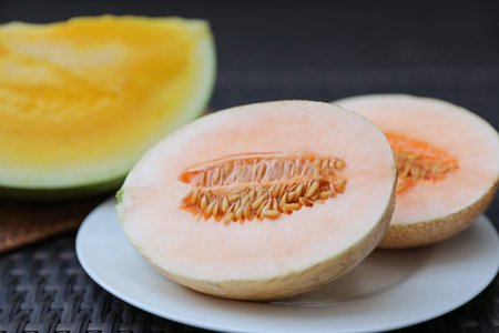 Ripe juicy tropical fruits on wicker table, closeup