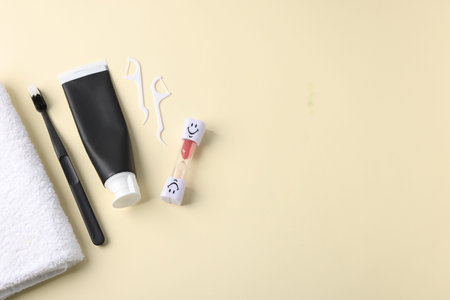 Different oral care products on beige background, flat lay. Space for text