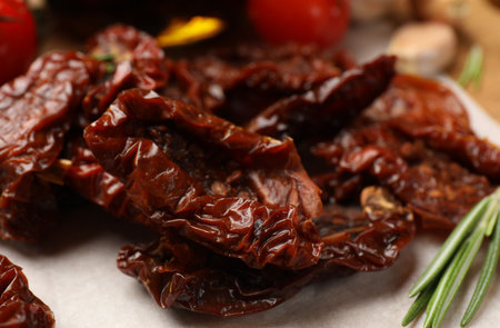 Tasty sun dried tomatoes and fresh vegetables on table, closeupの写真素材