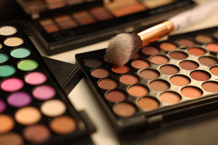 Different makeup products and brush on dressing table, closeupの写真素材