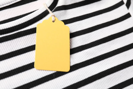 Cardboard tag on striped t-shirt, closeup viewの写真素材