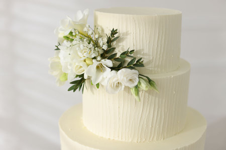 Delicious wedding cake with floral decor indoors, closeupの写真素材