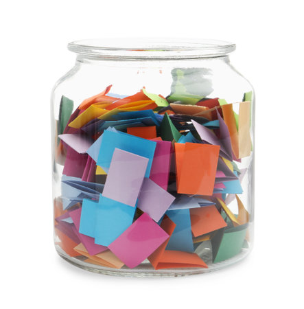 Colorful paper pieces in glass jar isolated on whiteの写真素材