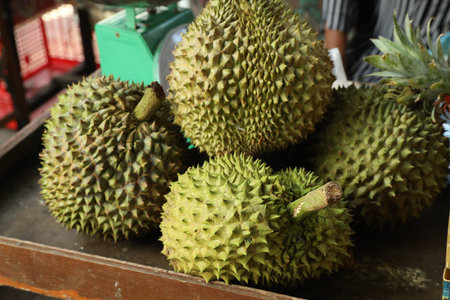 Fresh ripe durians on counter at market, closeup