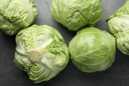 Fresh green cabbages on grey table, flat layの写真素材